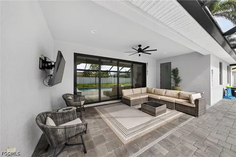 a living room with furniture and a floor to ceiling window