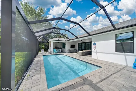 a view of a house with backyard and sitting area