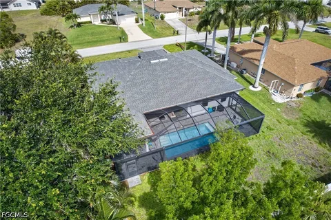 an aerial view of a house with a yard and lake view
