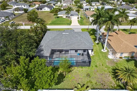 an aerial view of a house with yard swimming pool and outdoor seating