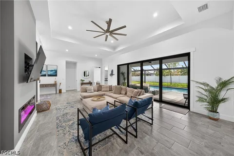 a living room with furniture and a floor to ceiling window