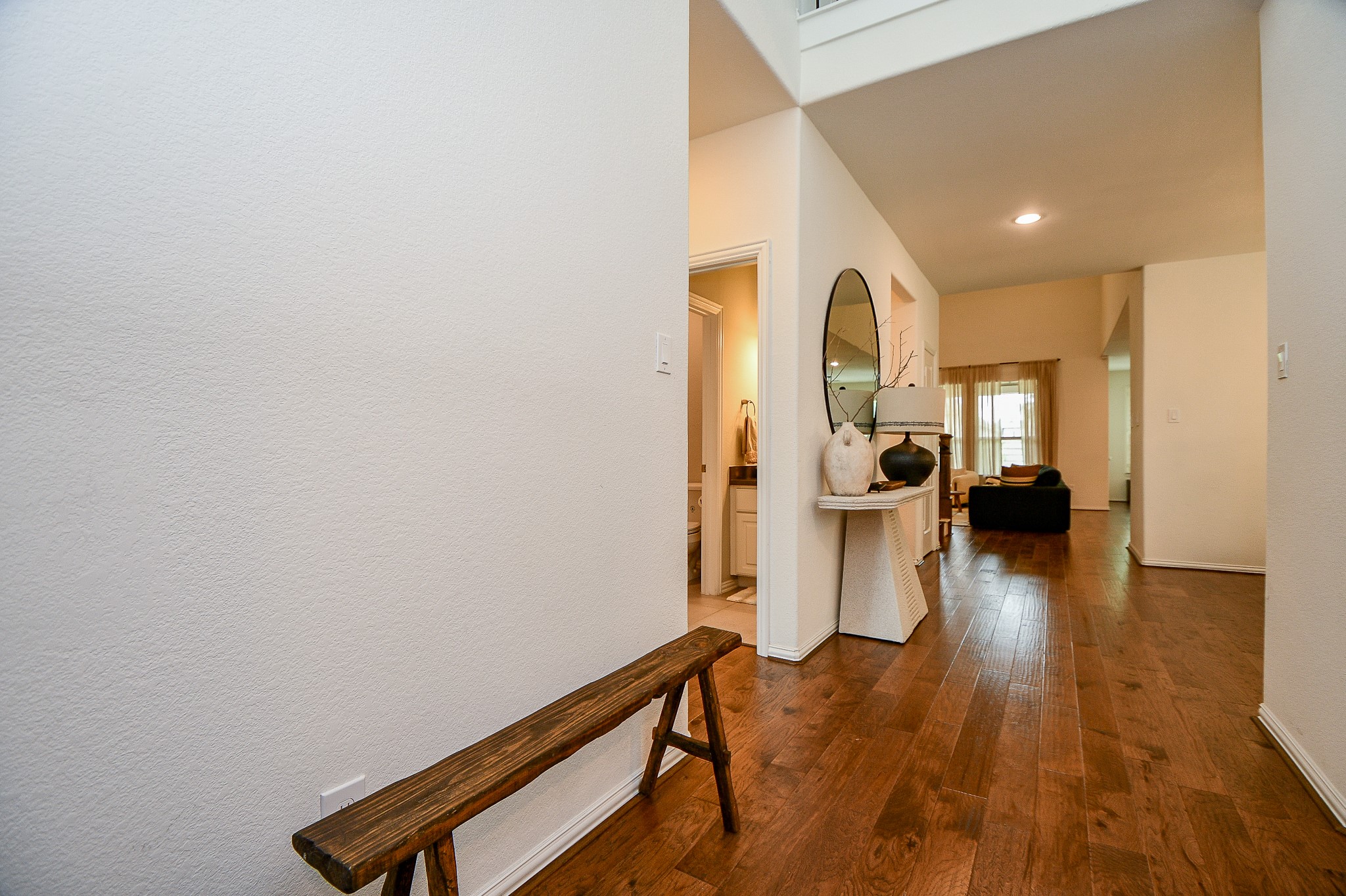 4523 Juniper Ridge Lane Manvel, TX 77578 - Photo 12 of 38 a view of a hallway with wooden floor and a bathroom