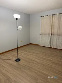 a view of a room with wooden floor