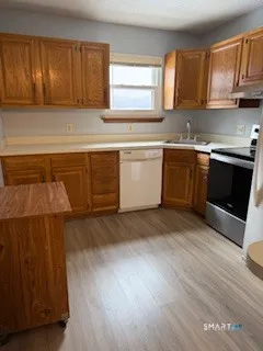 a kitchen with a sink cabinets and a window