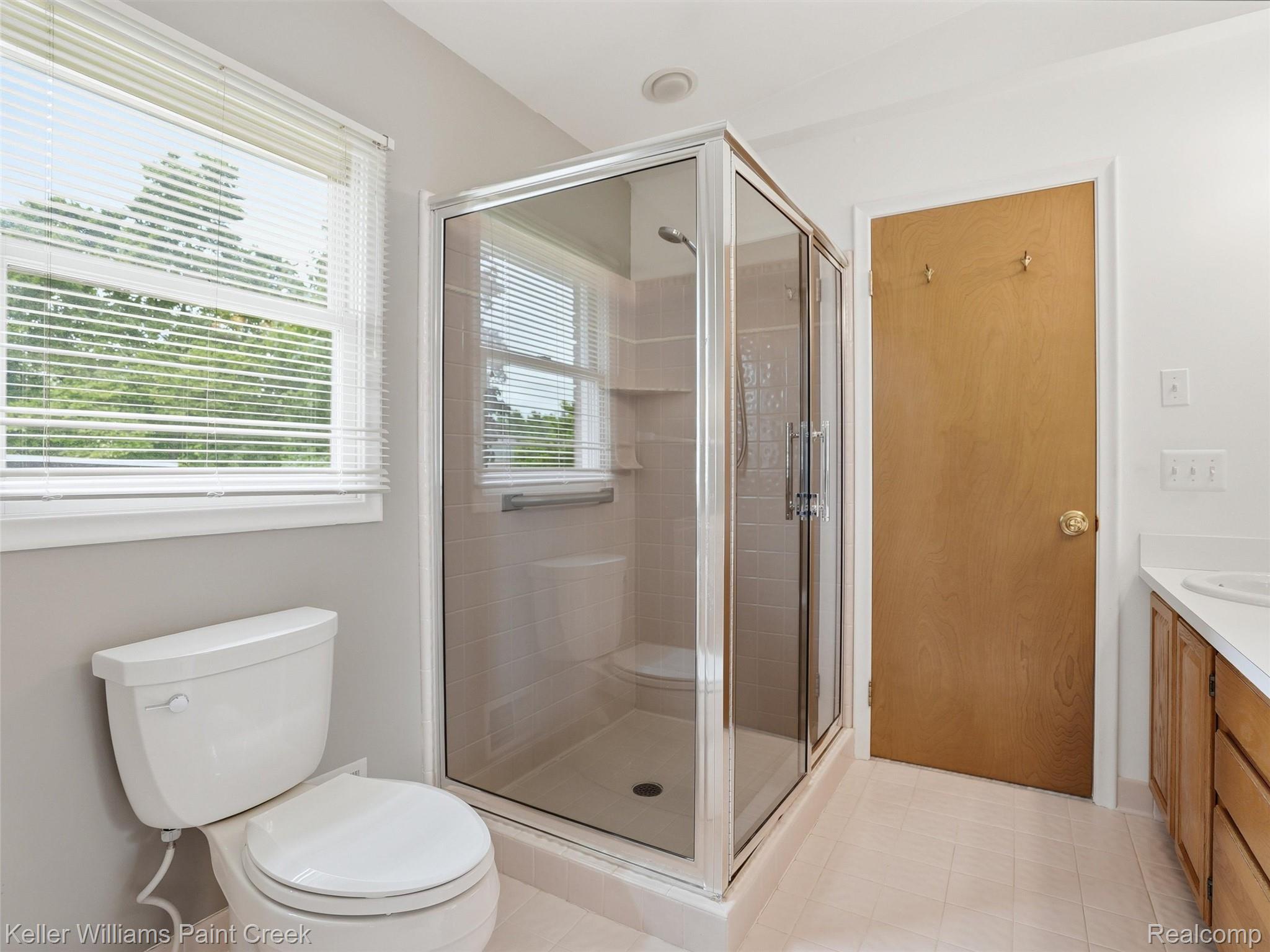 436 Broadleaf Drive Rochester, MI 48306 - Photo 26 of 41 Full bath featuring vanity, a stall shower, and light tile patterned floors