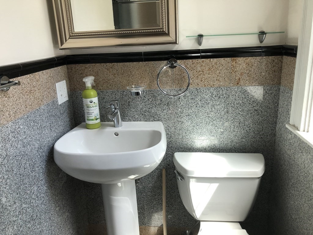96 St Paul Street, Unit 2 Brookline, MA 02446 - Photo 10 of 14 a bathroom with a toilet sink and mirror