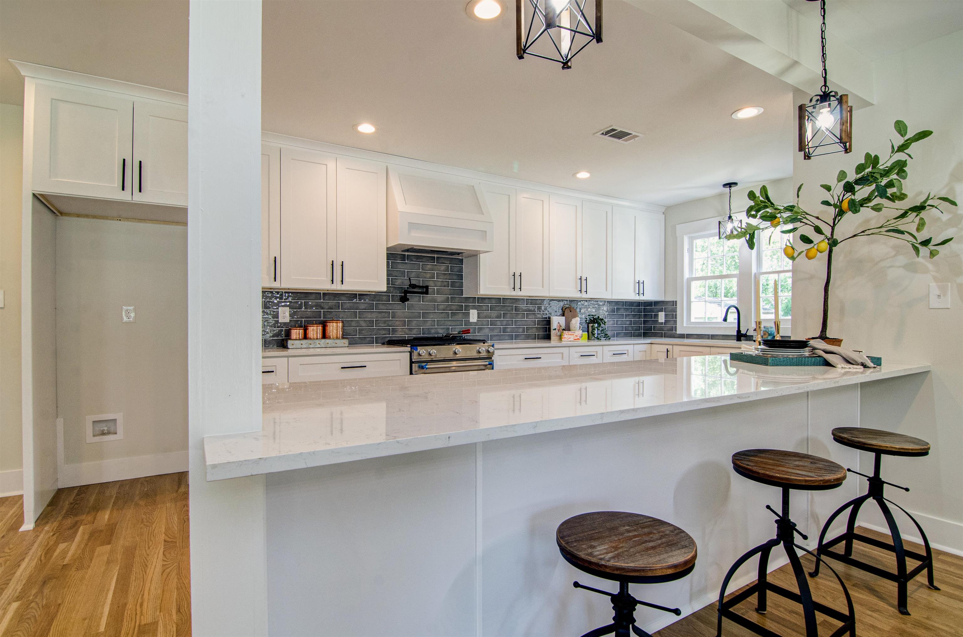 185 Alexander Street Memphis, TN 38111 - Photo 8 of 25 a kitchen with stainless steel appliances a table chairs refrigerator and sink