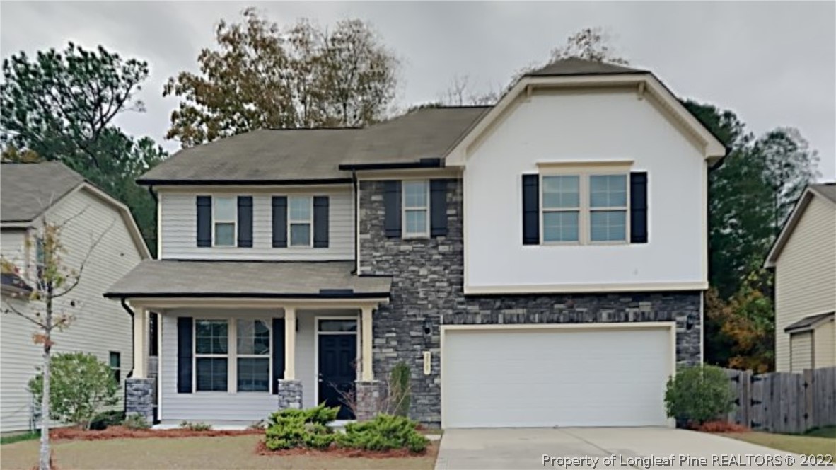 271 River Oak Street Spring Lake, NC 28390 - Photo 1 of 18 a front view of a house with garden
