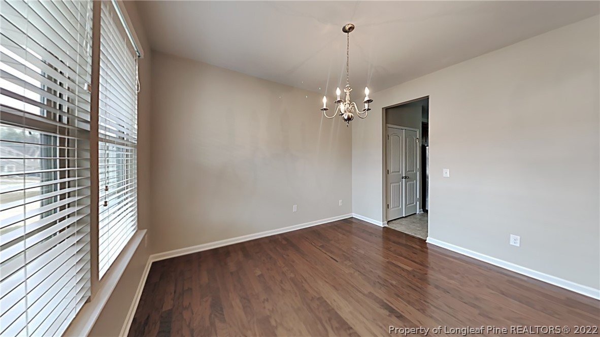 271 River Oak Street Spring Lake, NC 28390 - Photo 2 of 18 wooden floor in an empty room with a window