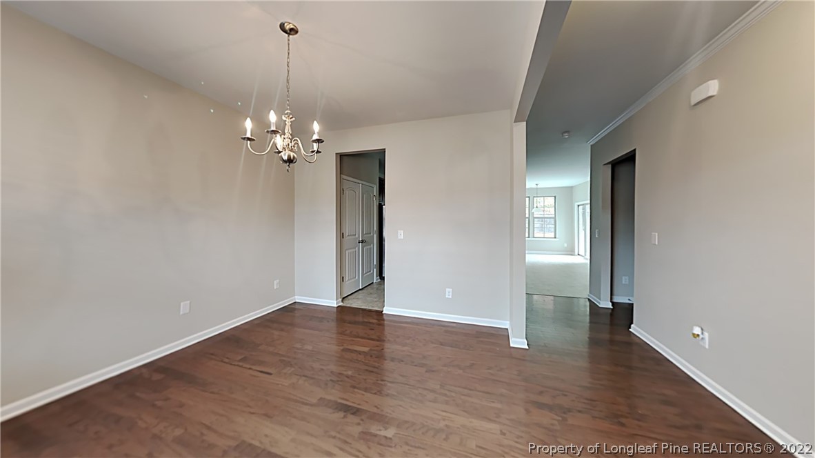 271 River Oak Street Spring Lake, NC 28390 - Photo 3 of 18 a view of a room with wooden floor and chandelier