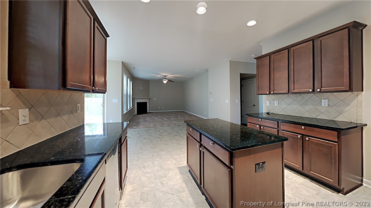 271 River Oak Street Spring Lake, NC 28390 - Photo 5 of 18 a kitchen with granite countertop a sink stove and cabinets