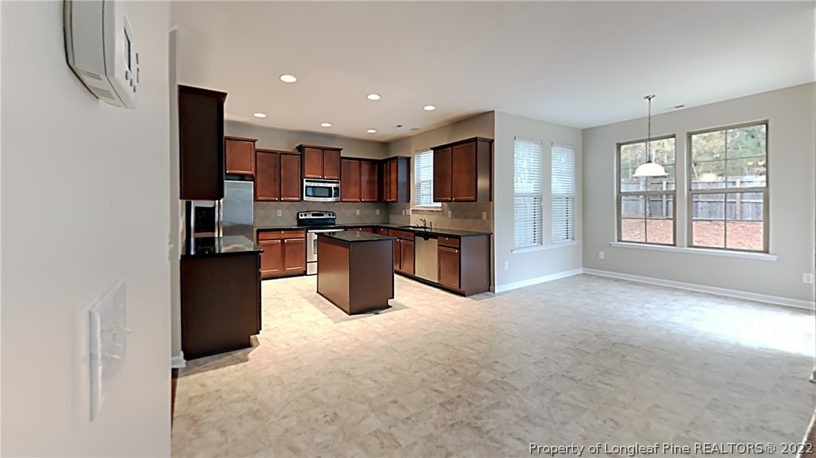 271 River Oak Street Spring Lake, NC 28390 - Photo 6 of 18 a view of kitchen with stainless steel appliances granite countertop a refrigerator and a stove top oven
