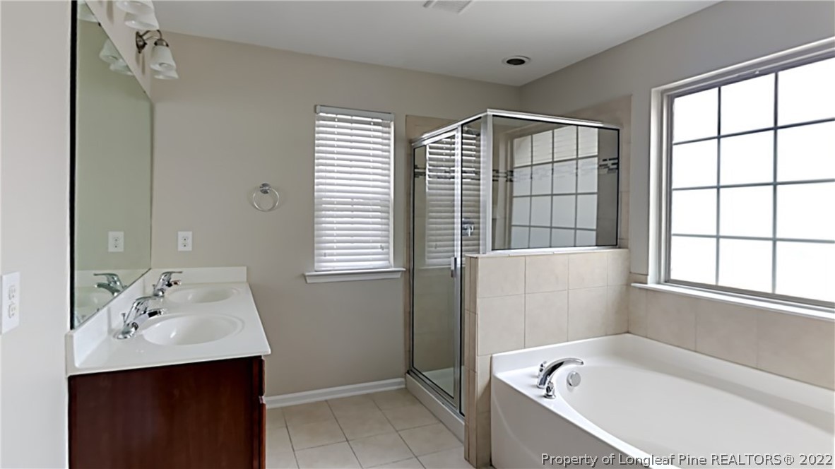 271 River Oak Street Spring Lake, NC 28390 - Photo 10 of 18 a bathroom with a bathtub sink and mirror