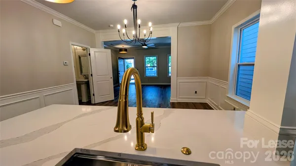 a kitchen with a sink and a mirror