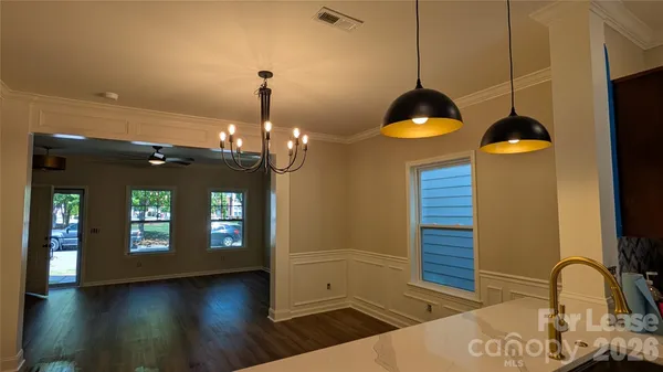 a view of a kitchen with a sink and chandelier