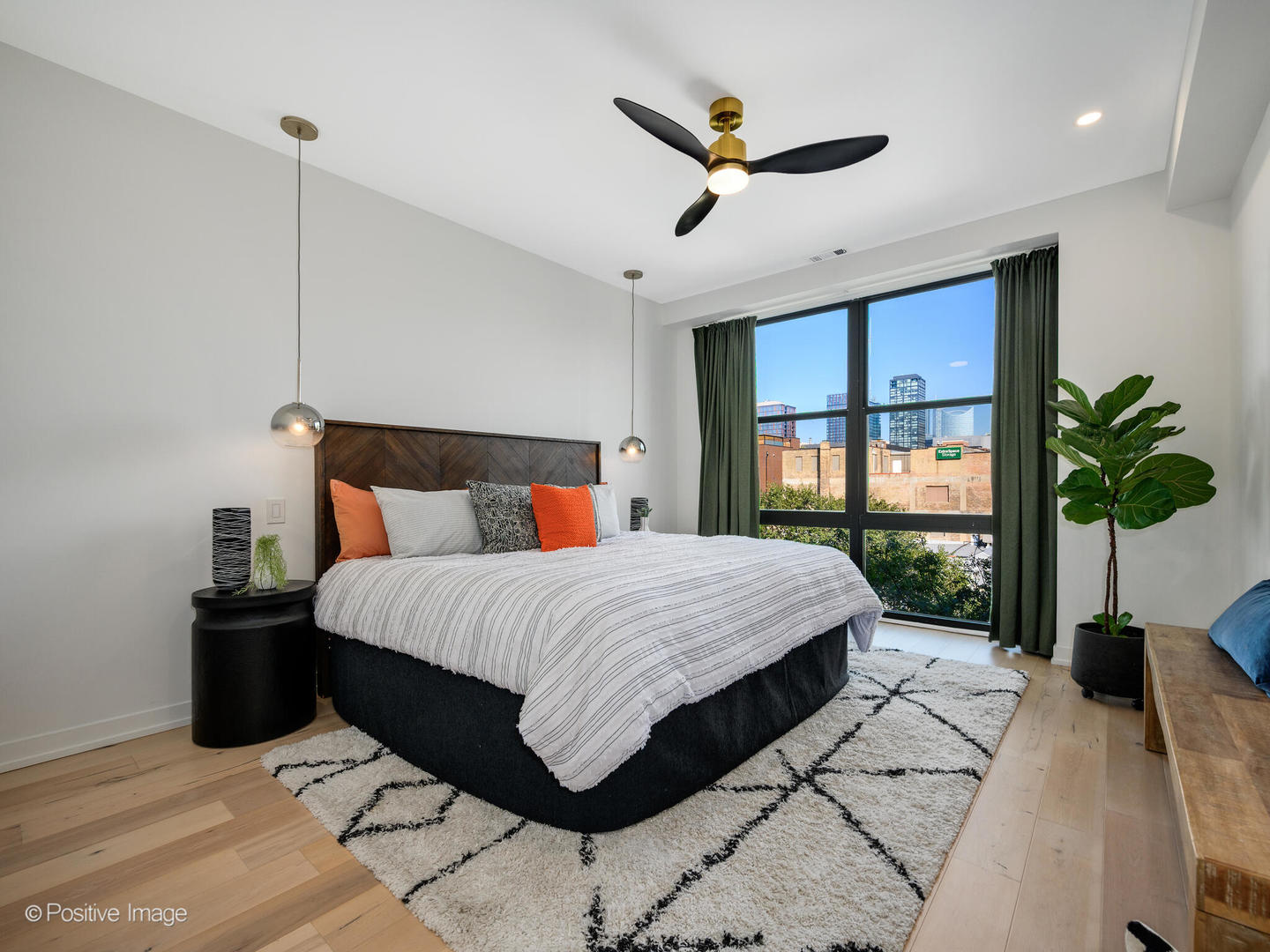 1260 West Washington Boulevard, Unit 404 Chicago, IL 60607 - Photo 14 of 26 a bed sitting in a bedroom next to a large window with a potted plant on a table