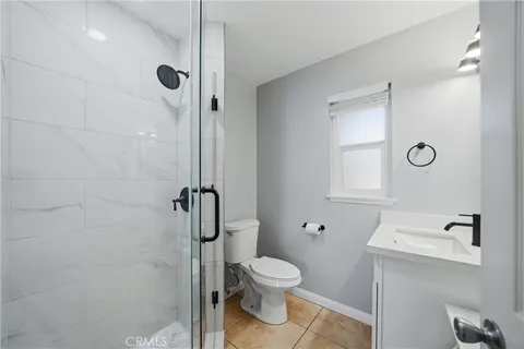 a bathroom with a toilet a sink and shower