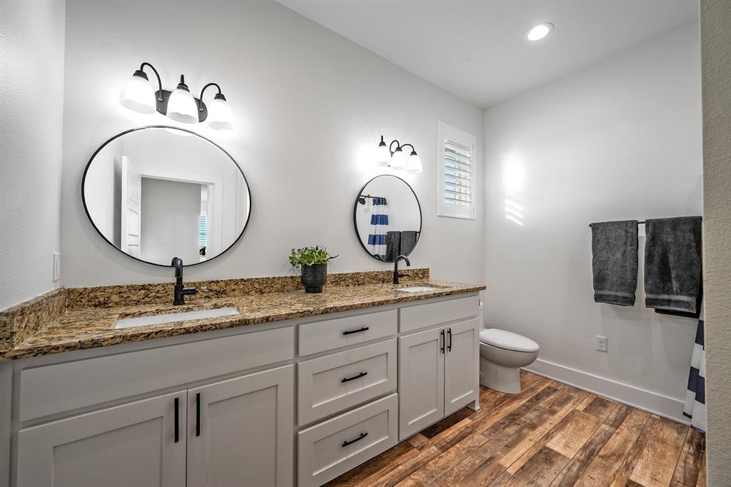 4509 Peach Tree Lane Kingston, OK 73439 - Photo 26 of 39 a bathroom with a toilet a sink and a mirror