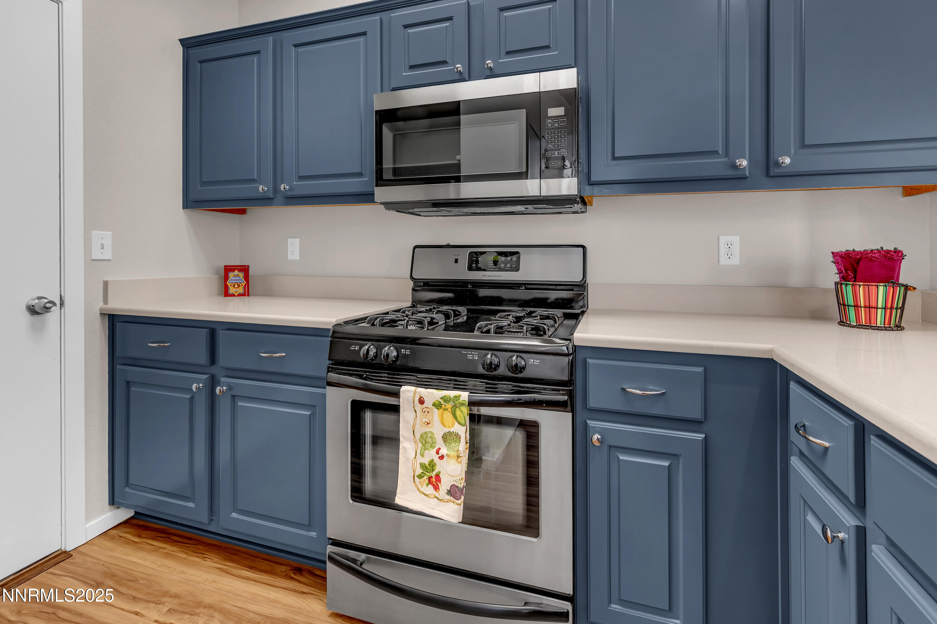 4301 Loreto Lane Reno, NV 89502 - Photo 13 of 36 a kitchen with granite countertop cabinets stainless steel appliances and wooden cabinets