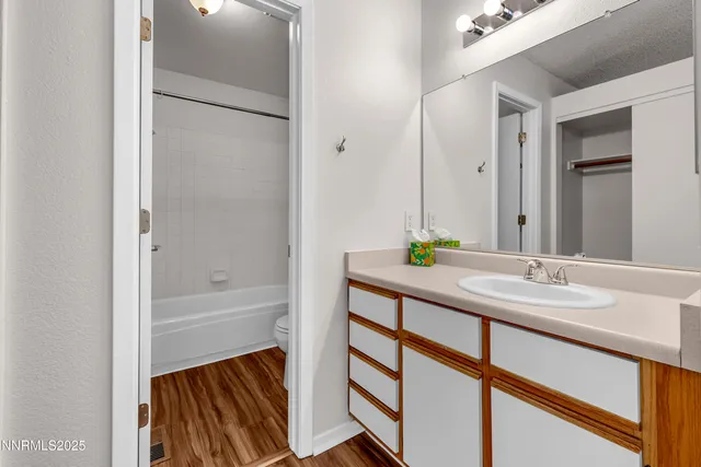 a bathroom with a toilet and a bath tub