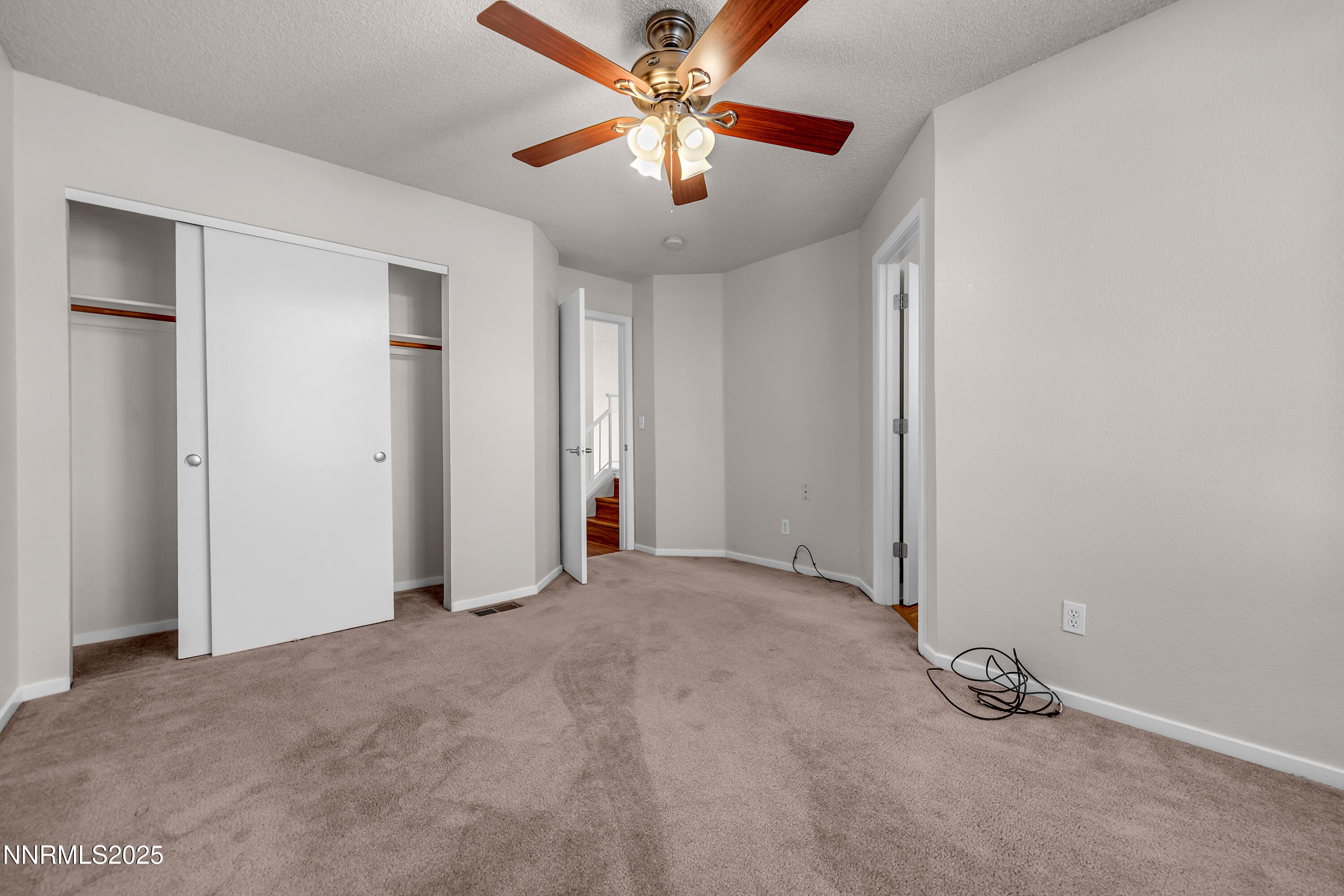 4301 Loreto Lane Reno, NV 89502 - Photo 23 of 36 an empty room with closet and a chandelier fan