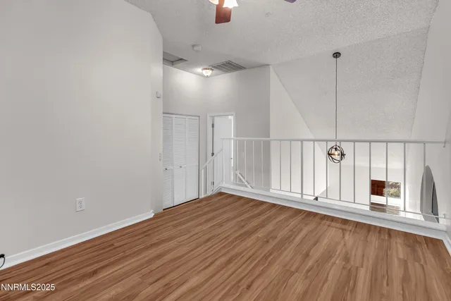 a view of a room with wooden floor and window