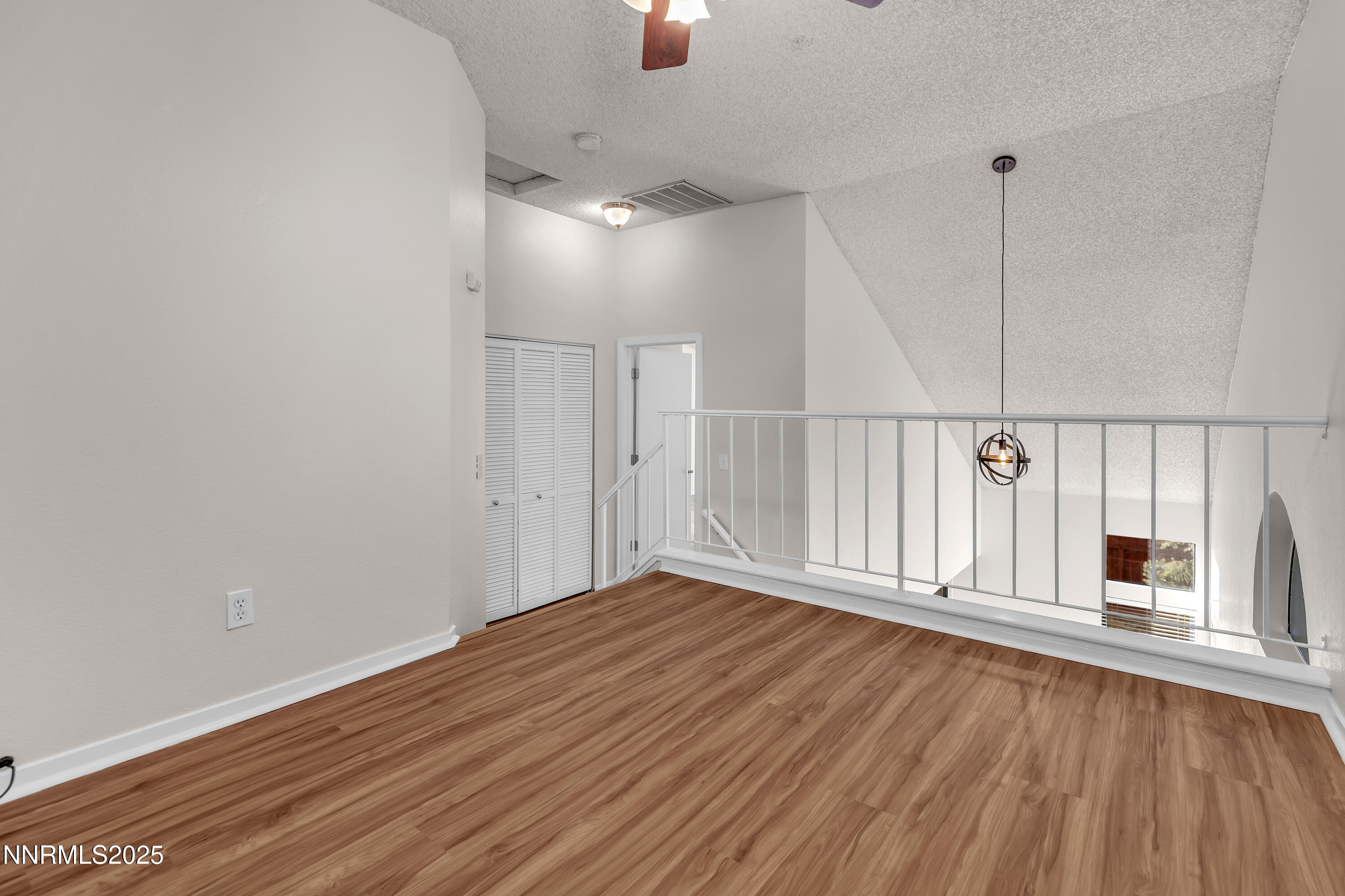 4301 Loreto Lane Reno, NV 89502 - Photo 29 of 36 a view of an empty room with wooden floor and fireplace