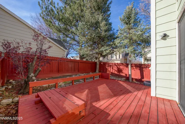 a backyard of a house with barbeque oven table and chairs