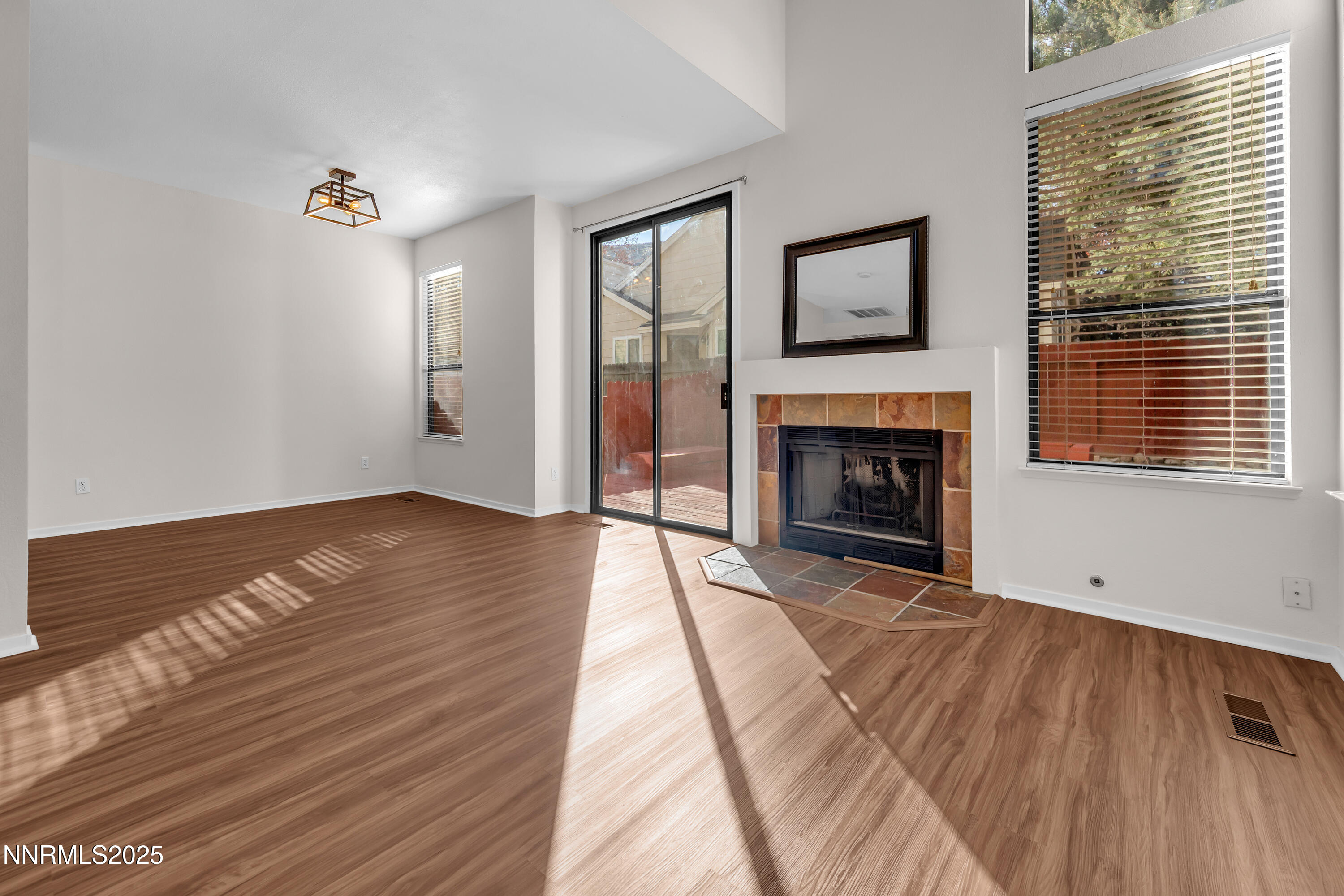 4301 Loreto Lane Reno, NV 89502 - Photo 4 of 36 a view of an empty room with wooden floor fireplace and a window