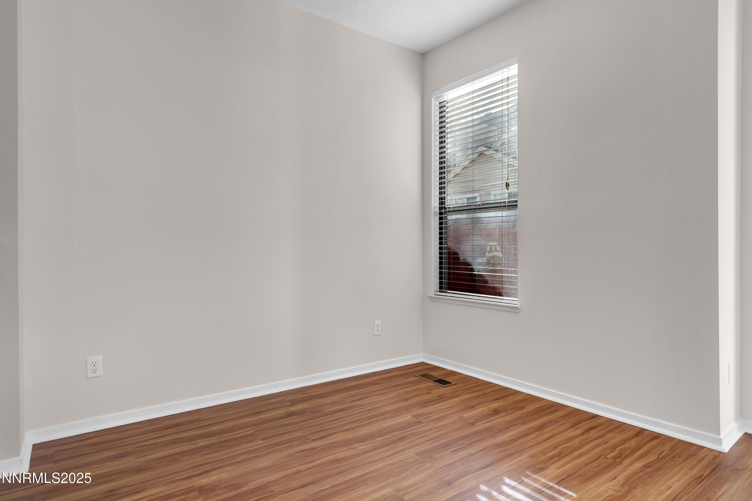 4301 Loreto Lane Reno, NV 89502 - Photo 7 of 36 a view of an empty room with wooden floor and a window