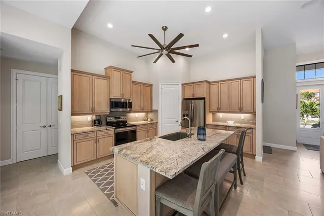 a kitchen with a stove a sink and a refrigerator