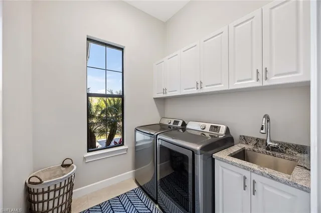 a utility room with sink dryer and washer