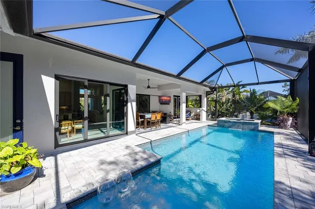 a view of a swimming pool with an outdoor seating