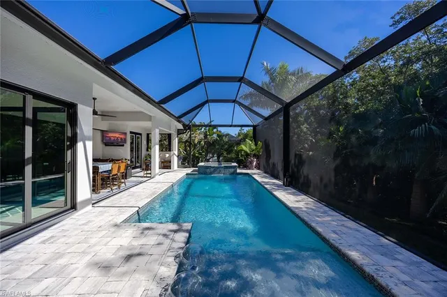 a view of a patio with a table and chairs under an umbrella