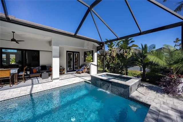 a living room with patio furniture and a potted plant