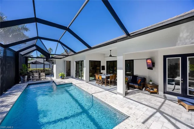a view of a patio with table and chairs under an umbrella
