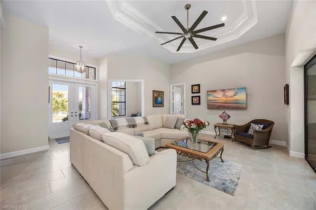 a living room with furniture ceiling fan and a window