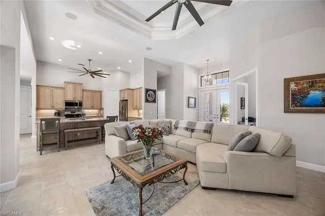 a living room with furniture kitchen view and a refrigerator