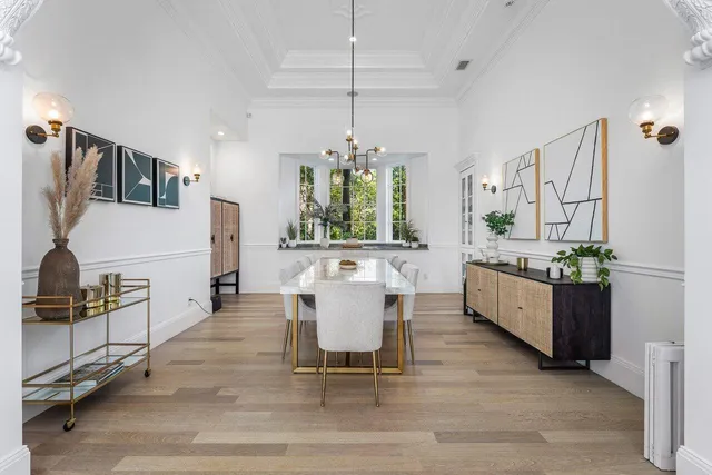 a living room with furniture and a large mirror