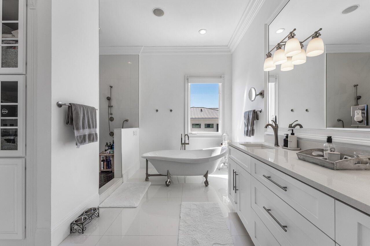 6080 Old Ocean Boulevard Ocean Ridge, FL 33435 - Photo 30 of 50 a spacious bathroom with a sink a mirror and a shower