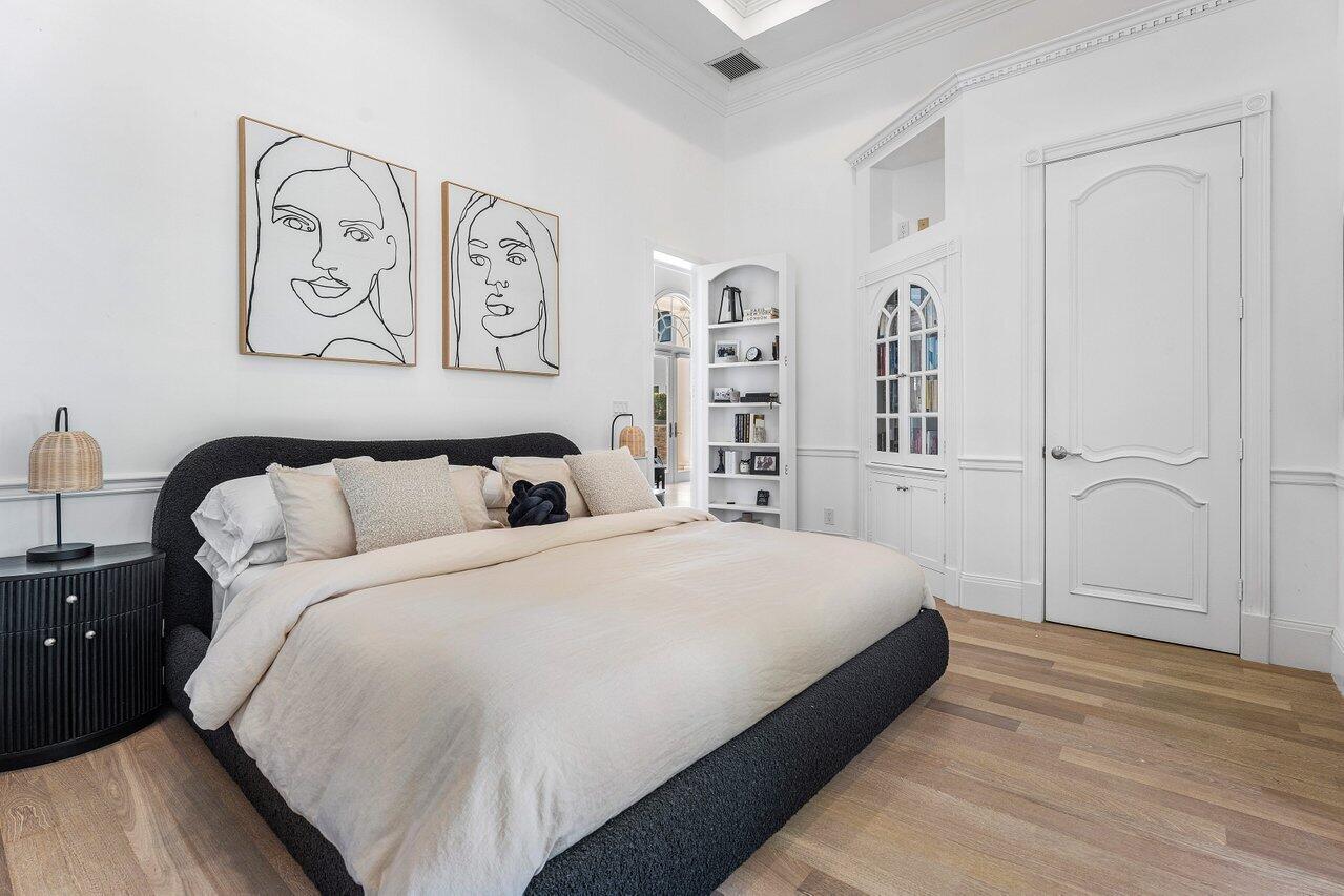 6080 Old Ocean Boulevard Ocean Ridge, FL 33435 - Photo 34 of 50 a large bed sitting in a bedroom next to a cabinet