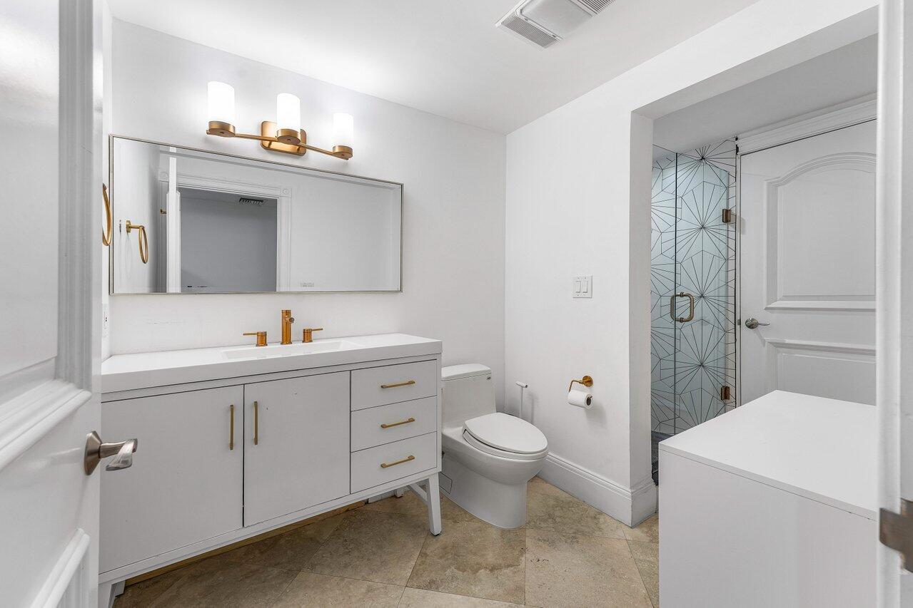 6080 Old Ocean Boulevard Ocean Ridge, FL 33435 - Photo 38 of 50 a bathroom with a sink a toilet and shower