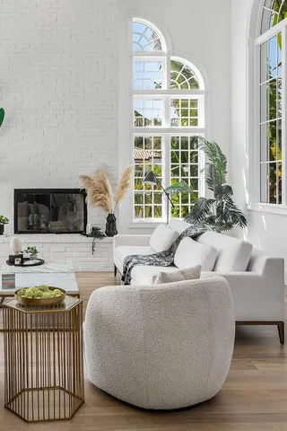 a living room with furniture wooden floor and a large window