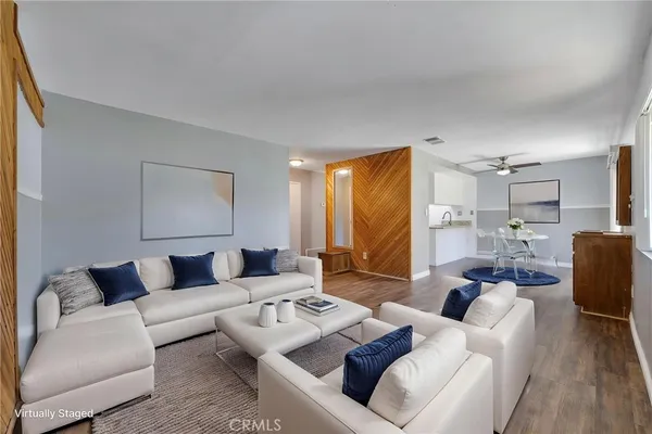 a view of an empty room with wooden floor