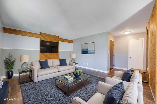 a view of a hallway with wooden floor and cabinet