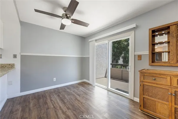 a dining room with furniture a window and wooden floor