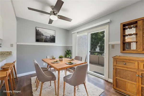 a kitchen with granite countertop white cabinets and wooden floor