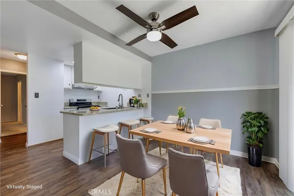 a kitchen with stainless steel appliances granite countertop a refrigerator and a stove