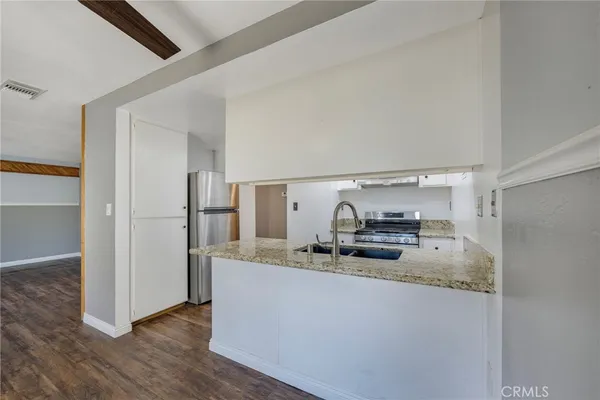 a kitchen with a sink stove and refrigerator