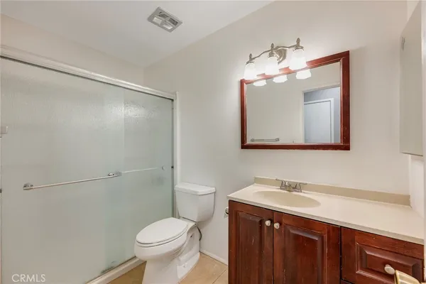 a bathroom with a sink vanity and a mirror